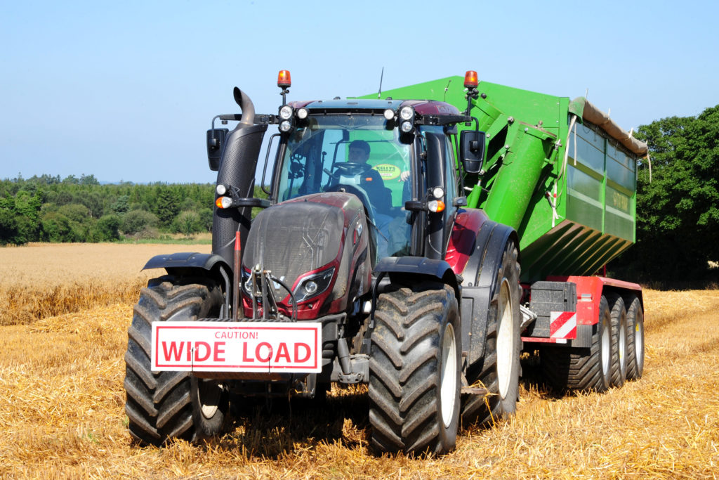 Valtra with chaser bin collecting oats