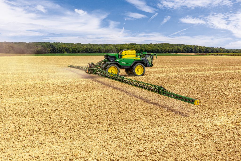 A rear shot of a new MY27 John Deere 500R sprayer in action
