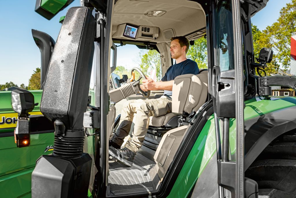 View looking into cab of new John Deere 6R 240 shows ergonomics and technology
