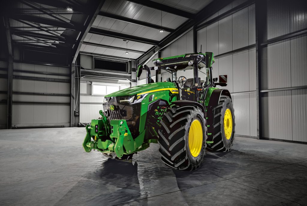 New John Deere 8R 410 parked in shed